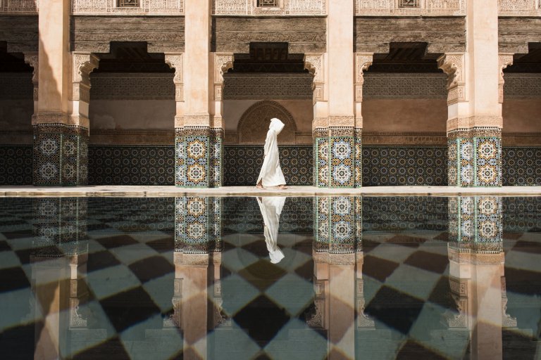Cities First Place Photo and caption by Takashi Nakagawa / National Geographic Travel Photographer of the Year Contest Ben Youssef Even though there were a lot of people in Ben Youssef, still here was more quiet and relaxing compare to the street outside in Marrakesh. I was waiting for the perfect timing to photograph for long time.